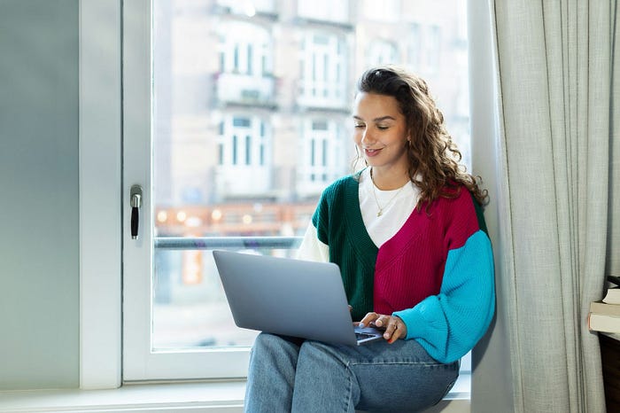 Woman looking at online job boards on computer.
