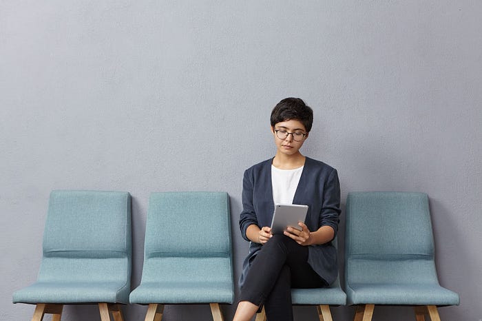 Woman reading a Job application online.